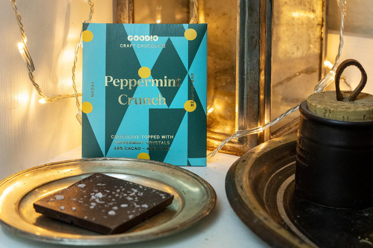 Goodio peppermint crunch chocolate bar with packaging on a decorative surface