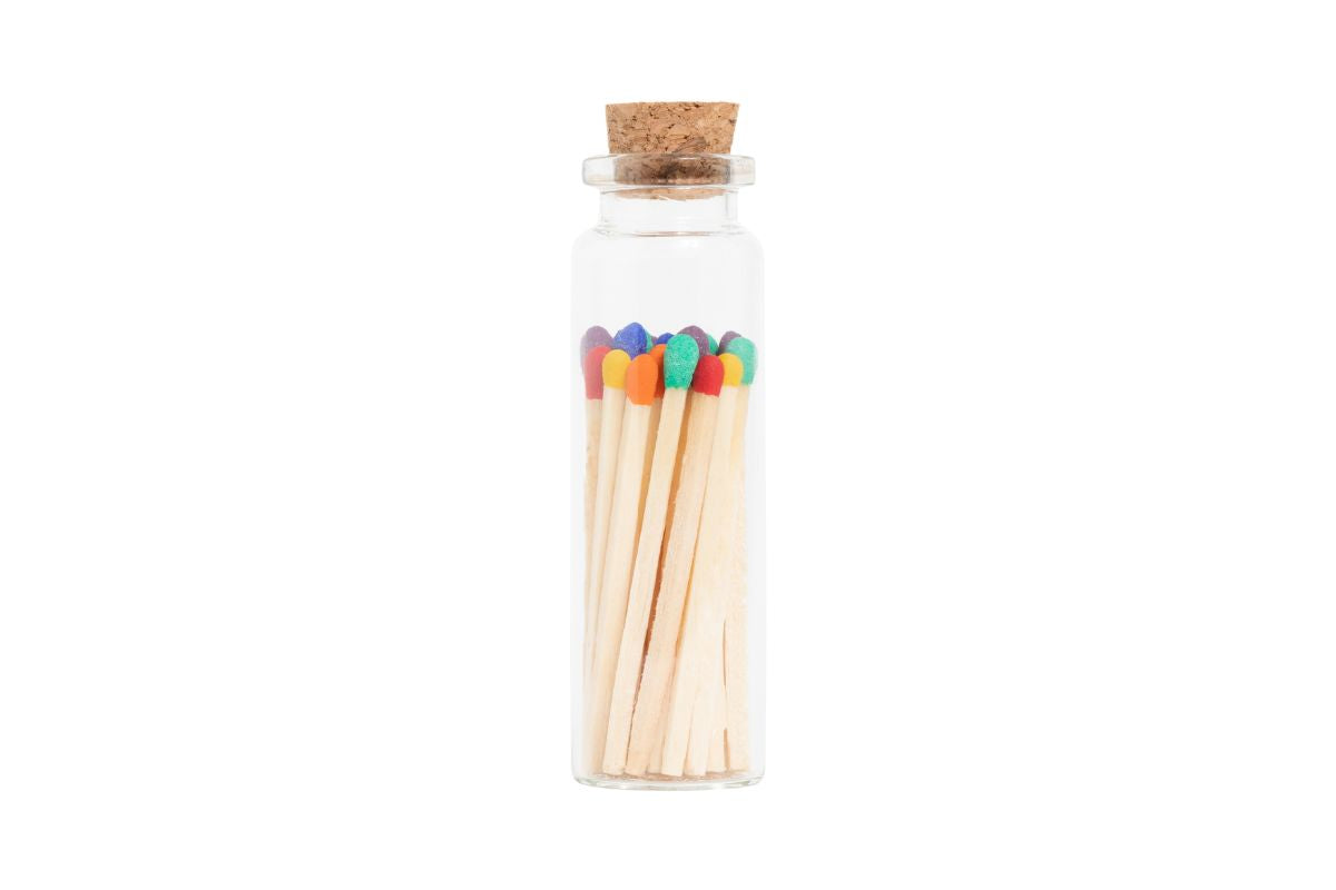 Jar of matches with colorful heads on a white background