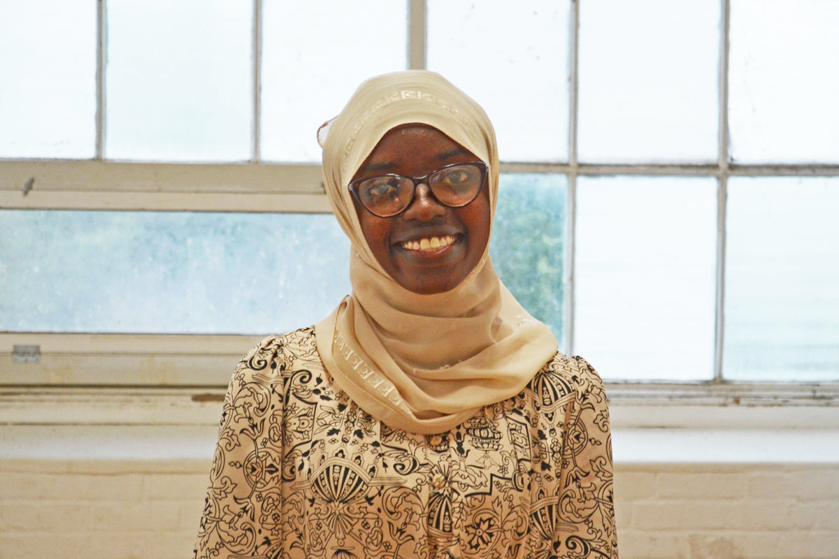 Candles that give back handmade by women artisan Lydia, who resettled to the U.S. from a refugee camp in Burundi.