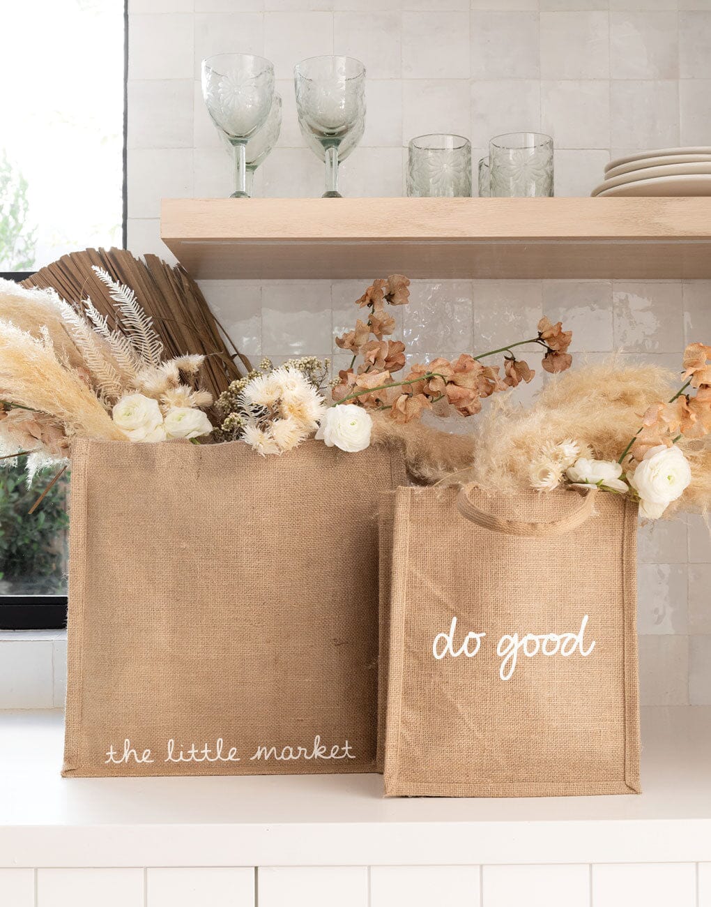 Medium Do Good Reusable Gift Tote In White Font On Desk | The Little Market