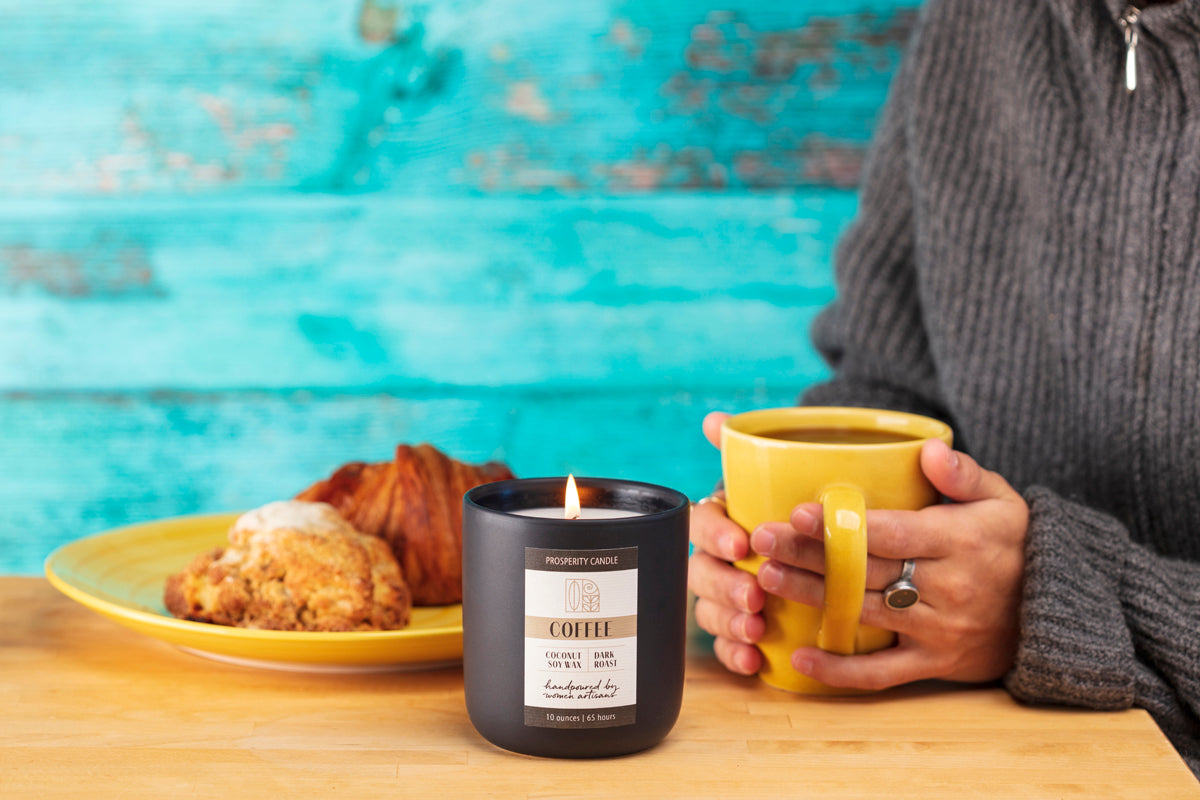 https://www.prosperitycandle.com/cdn/shop/products/Coffee_Candle_Croissant_grey_sweater_2022_12x8_72dpi_5d73f261-8e7e-4b41-9aef-53556eb878b2.jpg?v=1664460789&width=1500