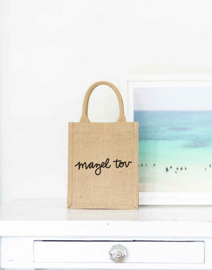 Small Mazel Tov Reusable Gift Tote In Black Font On Desk | The Little Market