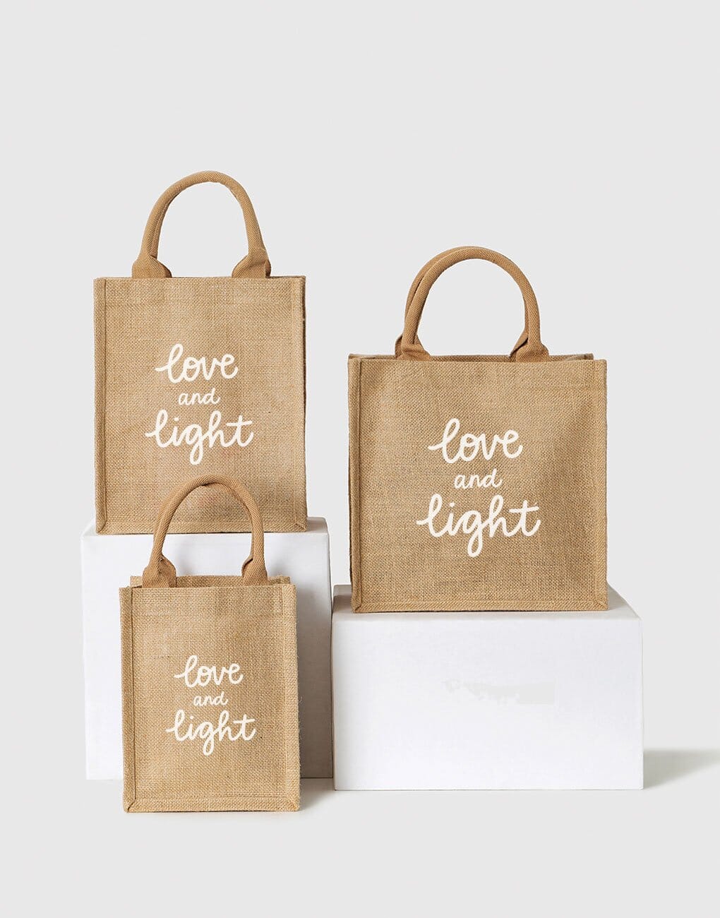 Small, Medium, And Large Love And Light Reusable Gift Totes In White Font | The Little Market