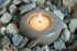 Hand-carved riverstone tea light made in Haiti by artisans with 100% pure beeswax tea lights.